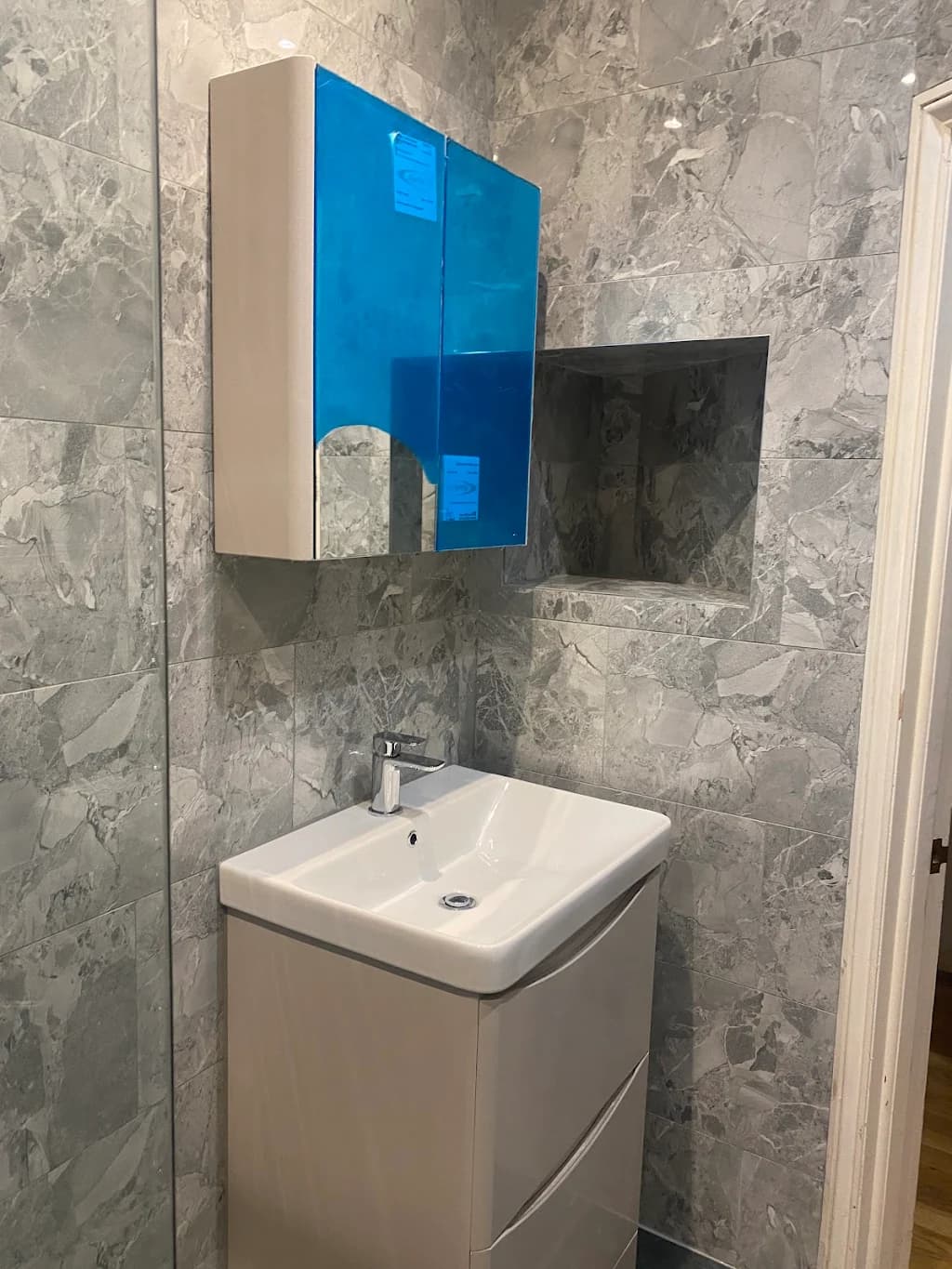 Grey marble tiled bathroom with modern vanity unit - Bathroom renovation Wimbledon