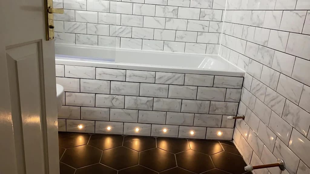 Luxury marble bathroom with black porcelain tiles and modern fixtures - Esher bathroom fitters
