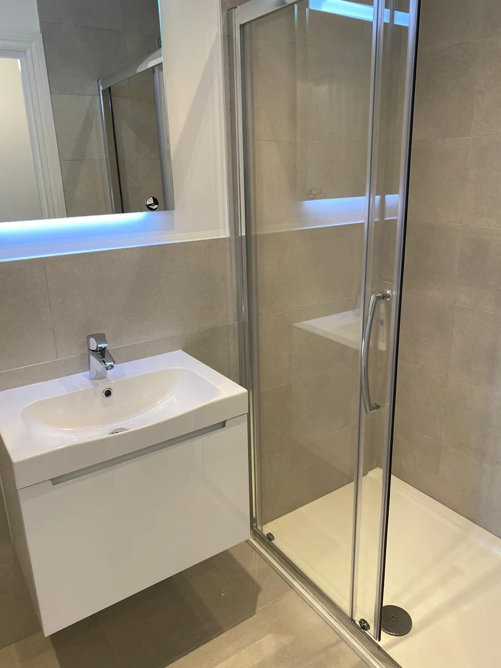 Modern bathroom renovation with white vanity unit and storage - Bathroom fitters Sutton